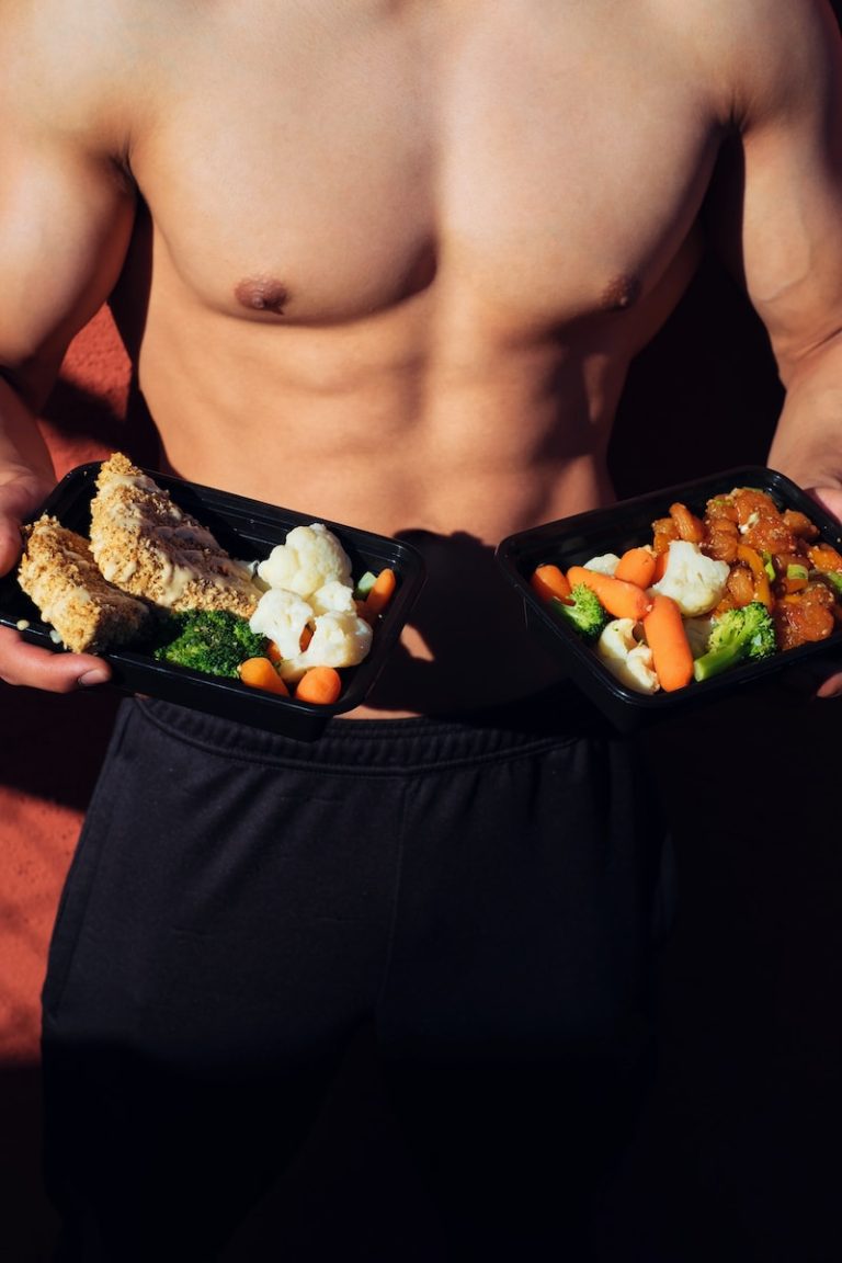 Eating seafood for weight loss topless man in black shorts holding cooked food